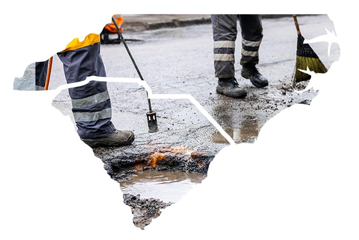 men fixing holes on road | emergency pothole repair