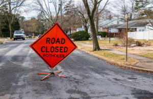 road closed sign | liable for pothole damage