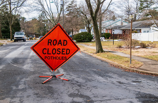 road closed sign | liable for pothole damage